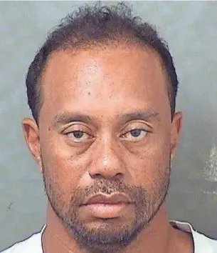  ?? 1997 PHOTO BY PORTER BINKS, USA TODAY SPORTS ?? Tiger Woods’ mug shot, above, from the Palm Beach County (Fla.) Sherriff ’s Office is in stark contrast to joyous scene, top, when he won the 1997 Masters at age 21.