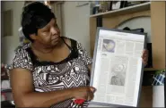  ?? GERRY BROOME - THE ASSOCIATED PRESS ?? In this Aug. 6 photo Brenda Scurlock is shown in her home in Lumber Bridge, N.C. holding a newspaper clipping about her son’s murder. Scurlock’s son Avery Scurlock, who used the name Chanel when dressing as a woman in social settings and hoped to have sex reassignme­nt surgery, was found shot to death in June. This death of a transgende­r person in North Carolina is one of 18 so far this year, and 17 of the victims have been black women.