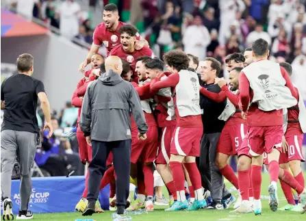  ?? — AFP photo ?? Akram Afif celebrates with teammates after scoring Qatar’s second goal.