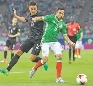  ?? MARTIN MEISSNER/THE ASSOCIATED PRESS ?? Mexico’s Marco Fabian, right, keeps New Zealand’s Dane Ingham at bay Wednesday in the Confederat­ions Cup in Sochi, Russia. Mexico won its Group A game 2-1.