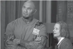  ?? Global Road Entertainm­ent ?? ■ Dave Bautista, left, and Jodie Foster are shown in a scene from "Hotel Artemis."
