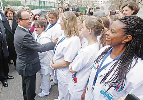  ??  ?? French President Francois Hollande is greeted by hospital employees as he arrives for a visit at the Kremlin Bicetre Hospital, south of Paris, as part of the World
AIDS Day, on Nov 30. (AP)