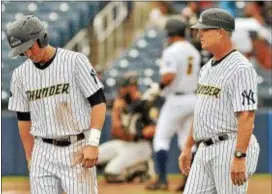  ?? KYLE FRANKO — TRENTONIAN PHOTO ?? Thunder’s Mandy Alvarez stands on third base next to manager Jay Bell during the third inning of a game against Akron on Wednesday morning.