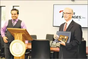  ?? Jean Falbo Sosnovich / Hearst Connecticu­t Media ?? Ansonia Mayor David Cassetti, left, presents Better Packages CEO Phil White with a proclamati­on and a key to the city.