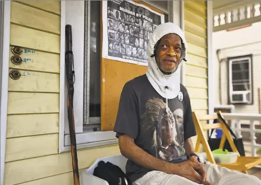  ?? Brian A. Pounds / Hearst Connecticu­t Media ?? Longtime activist and former Black Panther George Edwards hands out disposable gloves, condoms and bottles of cold water from his front porch in New Haven on Wednesday.