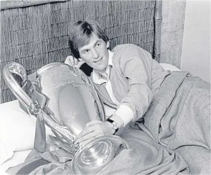  ??  ?? Kenny Dalglish woke up with the European Cup after scoring Liverpool’s winner against Club Brugge in 1978
