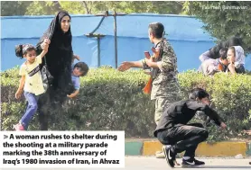  ?? Fatemeh Rahimavian ?? &gt; A woman rushes to shelter during the shooting at a military parade marking the 38th anniversar­y of Iraq’s 1980 invasion of Iran, in Ahvaz