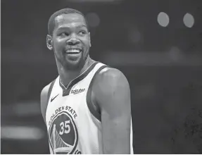  ?? HARRY HOW/GETTY IMAGES ?? Kevin Durant has averaged at least 40 points, five rebounds and five assists over a five-game span in the playoffs for the Warriors.