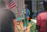  ?? SEAN D. ELLIOT THE DAY ?? New London High School senior Wendy Gethers walks across the stage Monday with her diploma cover.