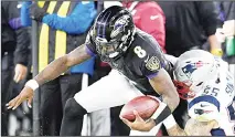  ??  ?? Baltimore Ravens quarterbac­k Lamar Jackson (8) is tackled by New England Patriots defensive end John Simon (55) during the first half of an NFL
football game on Nov 3 in Baltimore.
(AP)