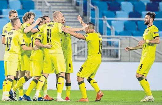  ??  ?? Not much social-distancing here as Czech Republic players celebrate in Slovakia. Now they have a night off when Scotland visit