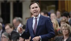  ?? ADRIAN WYLD, THE CANADIAN PRESS ?? Finance Minister Bill Morneau says the federal government is looking at ways to encourage people to stay in the labour force beyond the age of 65.