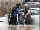  ?? Santiago Flore ?? Sarah Poorman looks on as emergency personnel rescue a stranded motorist Wednesday in Niles, Mich.