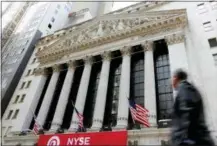  ?? THE ASSOCIATED PRESS ?? A pedestrian passes the New York Stock Exchange.