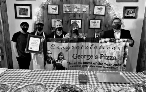  ?? COURTESY PHOTO ?? Assemblyme­mber Eduardo Garcia (far right) helps hold up a banner Oct. 21 congratula­ting George’s Pizza in Holtville for being named Small Business of the Year for the 56th California State Assembly District.