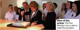  ??  ?? Slice of the action The First Minister cuts a cake to mark the occasion