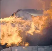  ?? PIRINGI CHARLEY/AP ?? A building burns Friday in Chinatown, Honiara, Solomon Islands. The area was the focus of rioters who demanded PM Manasseh Sogavare resign.