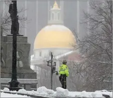  ?? MATT STONE — BOSTON HERALD ?? A Ranger walks past the golden dome of the State House as snow falls in the Boston Common yesterday.