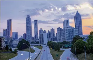  ?? ALYSSA POINTER/APOINTER@AJC.COM ?? The sun sets along the downtown Atlanta skyline May 14 as seen from the Jackson Street bridge. Housing prices would rise, rents would soar and many lower-income residents would be forced to find more modest homes in the area around an Amazon HQ2, according to experts.