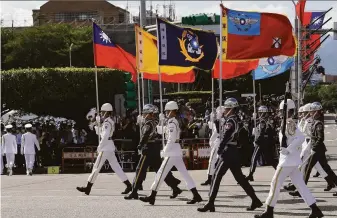  ?? Chiang Ying-ying / Associated Press ?? A military honor guard joins National Day celebratio­ns in Taiwan’s capital of Taipei. “Nobody can force Taiwan to take the path China has laid out for us,” President Tsai Ing-wen said.