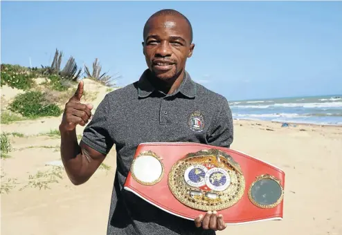  ?? Picture: Hayden Jones/SA Boxing Talk ?? DEFYING THE SANDS OF TIME
World flyweight champion Moruti Mthalane, posing with his belt at a beach in Tunis yesterday, started his profession­al boxing career in 2000.