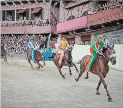  ?? ANDY HASLAM PHOTOS NYT ?? Palio jockeys ride bareback, dressed in the colours of their contrada.