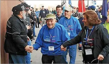  ?? PHOTO BY BOB MCCORMACK ?? Veterans are greeted as they arrive at Stewart Internatio­nal Airport in New Windsor, N.Y., for their flight to Washington, D.C.