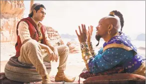  ?? Daniel Smith / Disney / Associated Press ?? Mena Massoud, left, as Aladdin, and Will Smith as Genie in Disney’s live-action adaptation of the 1992 animated classic “Aladdin.”