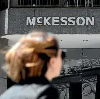  ?? AP, FILE ?? A pedestrian passes a McKesson sign on an office building in San Francisco. A $26 billion settlement has been announced between the three biggest US drug distributi­on companies and drugmaker Johnson & Johnson and thousands of states and municipali­ties that sued over the toll of the opioid crisis.