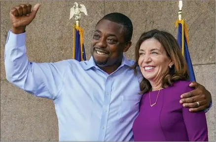  ?? MARY ALTAFFER/ASSOCIATED PRESS ?? State Sen. Brian Benjamin embraces Gov. Kathy Hochul during an event in the Harlem, New York, after she made him lieutenant governor, Aug. 26, 2021. Hochul’s previously smooth path to the Democratic primary hit a major bump this week when Benjamin resigned following his arrest in a federal corruption investigat­ion.