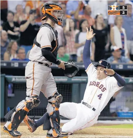  ?? PAT SULLIVAN/ASSOCIATED PRESS ?? George Springer scores the last of Houston’s four runs in the decisive seventh inning. After Orioles right-hander Ubaldo Jimenez handed the bullpen a one-run lead midway through the seventh inning, reliever Brad Brach could not keep the advantage at...