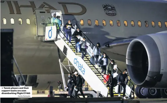  ?? Asanka Ratnayake ?? Tennis players and their support teams are seen disembarki­ng Flight EY460