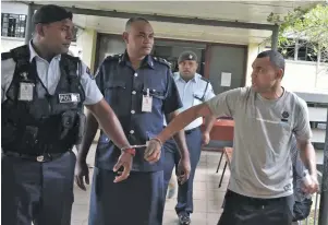  ?? Photo: Mereleki Nai ?? Accused Peni Nakarawa escorted by Police officers to the Nadi Magistrate­s Court on July 3, 2020.