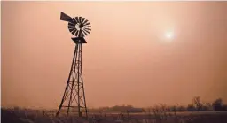  ?? TRAVIS HEYING/AP ?? Dust from heavy winds obscures the sun Wednesday in Jetmore, Kan., as winds caused tornadoes and downed power lines across the region.