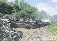  ??  ?? TRAIN OF THOUGHT: A cargo train derailed near Pha Sadej station in Saraburi’s Kaeng Khoi district yesterday. The State Railway of Thailand is planning a mass expansion project.