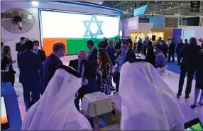  ?? (AP/Jon Gambrell) ?? Emirati and Israeli flags flash across a screen Monday in the Israel Aerospace Industries stand at the Dubai Air Show in Dubai, United Arab Emirates. Israel is taking part in the Dubai Air Show for the first time after the UAE recognized the country last year.