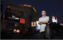  ?? K.M. CANNON — LAS VEGAS REVIEW-JOURNAL VIA AP ?? Reporter Jeff German poses with Planet Hollywood in the background on the Strip in Las Vegas on June 2.