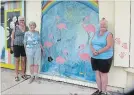  ?? ANNIE PASQUARIEL­LO SPECIAL TO THE NIAGARA FALLS REVIEW ?? Volunteers Jane Seaborne-Davies and Angela Stadelman, from left, along with Advancing Crystal Beach president Orma Bleeks display a mural on Derby Road.