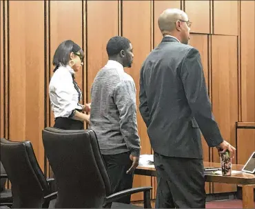  ?? CLEVELAND.COM ?? Frank Q. Jackson Jr., standing between attorneys Sydney Saffold (left) and Jeffrey Saffold, pleaded guilty Wednesday to a misdemeano­r assault charge in the middle of his trial on felonious assault and abduction charges.