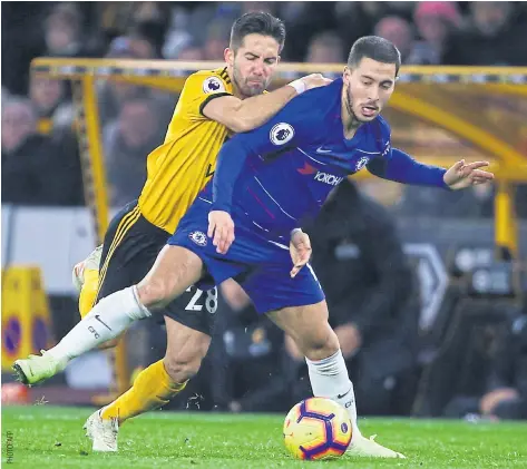  ??  ?? Chelsea’s Eden Hazard, right, vies with Wolverhamp­ton’s Joao Moutinho during their Premier League match on Wednesday.