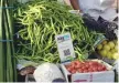  ?? — AFP ?? A sign advertisin­g Indian electronic and cellpohne-based payment system PAYTM hangs at a roadside vegetable stall in Mumbai.