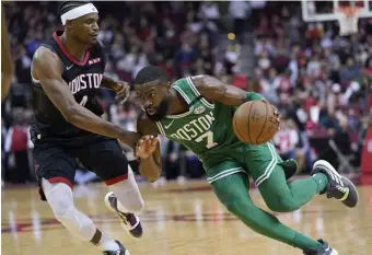  ??  ?? GUTTING IT OUT: Celtics guard Jaylen Brown, right, drives to the basket as Houston Rockets forward Danuel House Jr. defends.