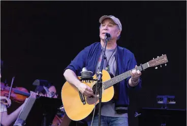  ?? Tribune News Service ?? ■ Paul Simon performs during the Eaux Claires Music Festival in Eau Claire, Wis.