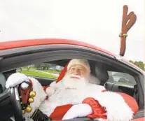 ?? KENNETH K. LAM/BALTIMORE SUN PHOTOS ?? Carman Peltzer plays Santa Claus at events and usually arrives in his “red nosed” Mustang with the license plate “MYRDSLD.”
