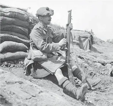  ?? CANADIAN LIBRARY AND ARCHIVES ?? A Highlander cleans his Lee-Enfield rifle in 1916. The Lee-Enfield’s powerful .303 cartridge was famous for killing enemy soldiers with one shot, and it’s equally good at stopping a charging polar bear.