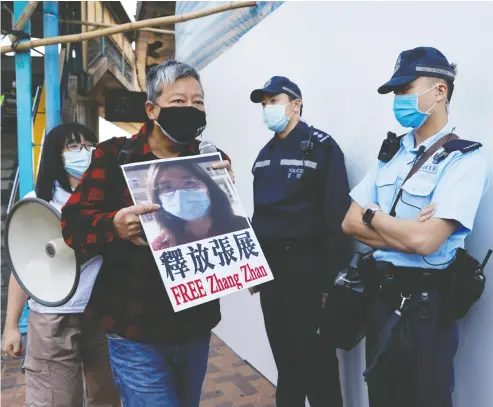  ?? Tyrone Siu / Reuters ?? Pro- democracy supporters urge for the release of 12 Hong Kong activists arrested as they reportedly sailed to Taiwan for political asylum, as well as journalist Zhang Zhan on the Mainland, outside China’s Liaison Office in Hong Kong.