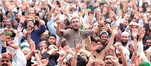  ??  ?? Members of the Tehreek-e-Labbaik Pakistan, a political party, shout slogans during a sit-in in Rawalpindi on Monday. (Reuters)