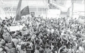  ?? Louai Beshara AFP/Getty Images ?? SYRIANS mass outside the U.N. office in Damascus to protest the “unjust American aggression.” “The Iraqi scenario will not be repeated in Syria,” read one banner, referring to the 2003 U.S.-led invasion of Iraq.