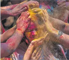  ?? Picture: AP ?? A girl has her face smeared with coloured powder as they celebrate Holi, the festival of colours in Mumbai, India, Monday, March 25, 2024.