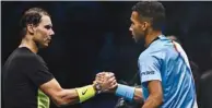  ?? (AFP) ?? Spain’s Rafael Nadal (left) and Canada’s Felix Auger-Aliassime shake hands after the latter won their round-robin match at the ATP Finals in Turin.